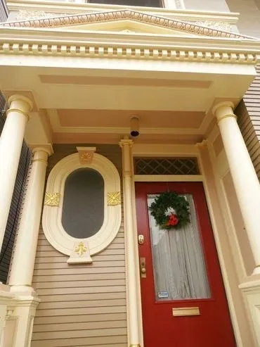 A door with a wreath on it and a window.